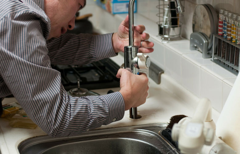 plumber fixing a pipe of sink
