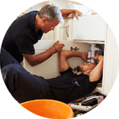 Two plumber men fixing kitchen sink in sydney
